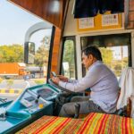 Een buschauffeur in Nederland achter het stuur van een bus, met aandacht voor verkeersveiligheid en leeftijdseisen.